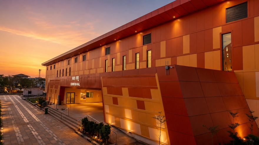 Aakash management development facility lit at night, peaked roof